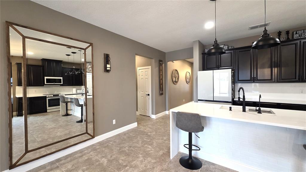5531 Cypress Hill Road Winter Garden, FL 34787 - Photo 6 of 62 a kitchen with stainless steel appliances kitchen island a refrigerator and a sink