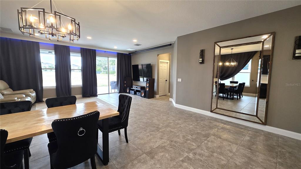 5531 Cypress Hill Road Winter Garden, FL 34787 - Photo 10 of 62 a view of a dining room with furniture and chandelier