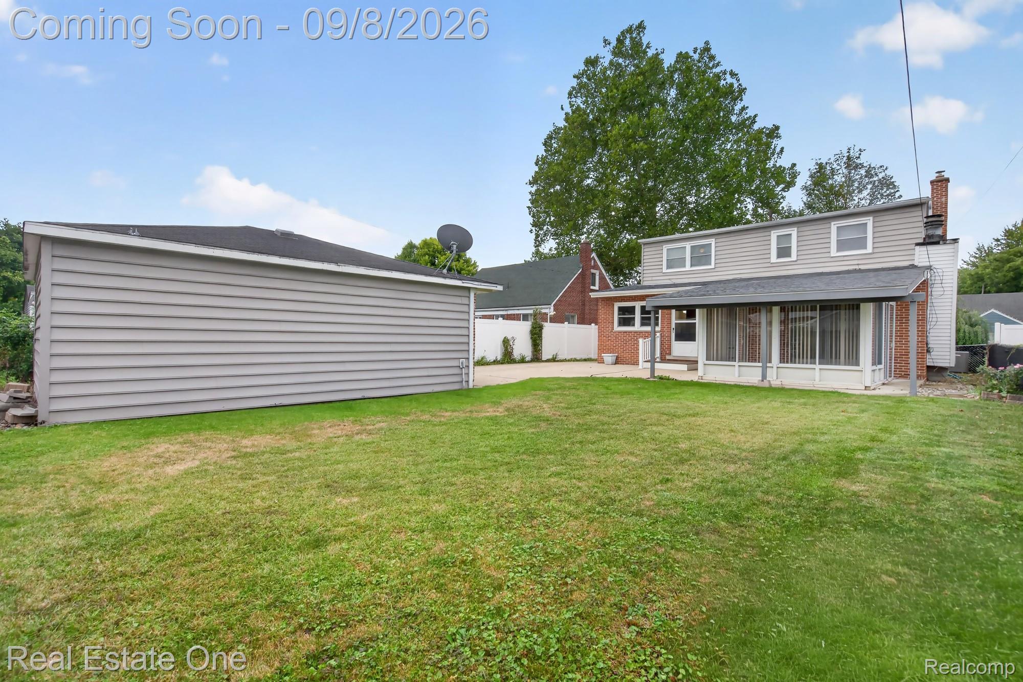 7961 Merrick Street Taylor, MI 48180 - Photo 35 of 39 Expansive lawn area with a detached structure featuring gray horizontal siding and a black shingle roof