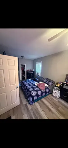 a bedroom with a bed and a potted plant