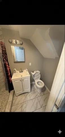 a view of a room with furniture and wooden floor