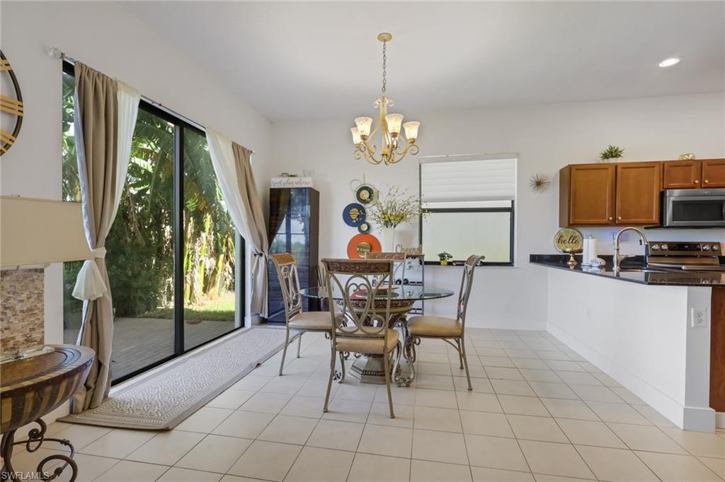 5289 Beckton Road Immokalee, FL 34142 - Photo 8 of 37 a view of a dining room with furniture a chandelier and window