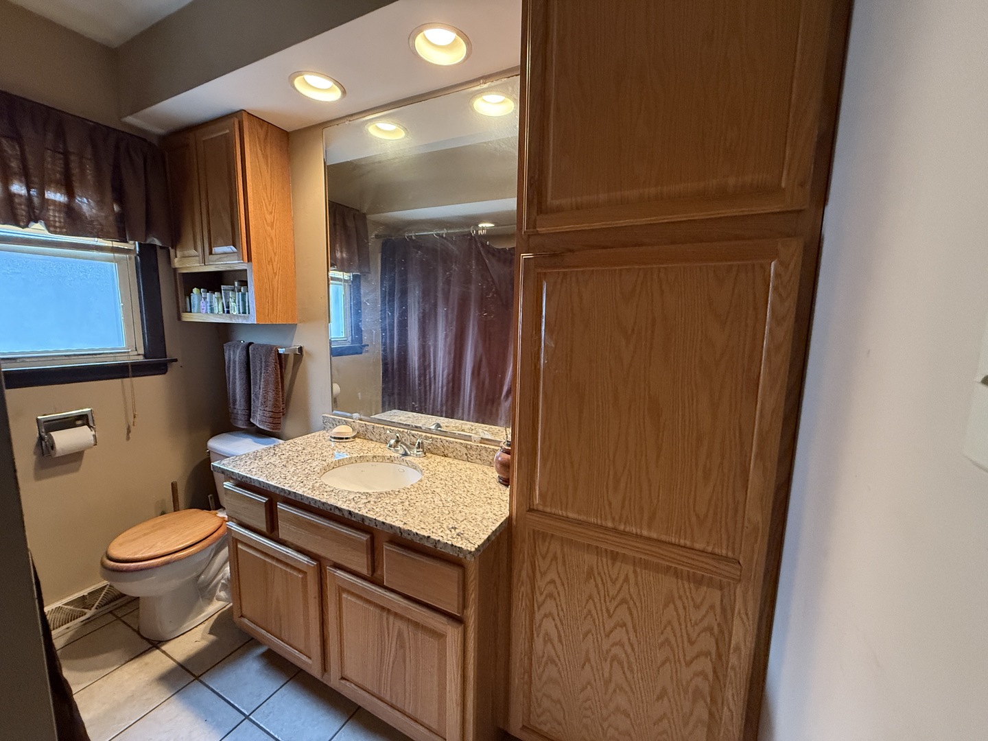 18316 Sherman Street Lansing, IL 60438 - Photo 12 of 14 a bathroom with a granite countertop sink toilet and a mirror