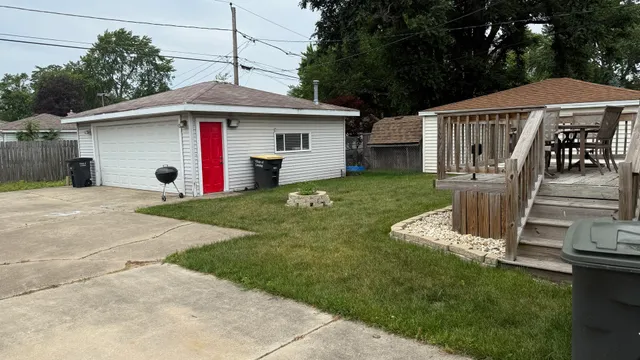 a view of a house with a yard and furniture