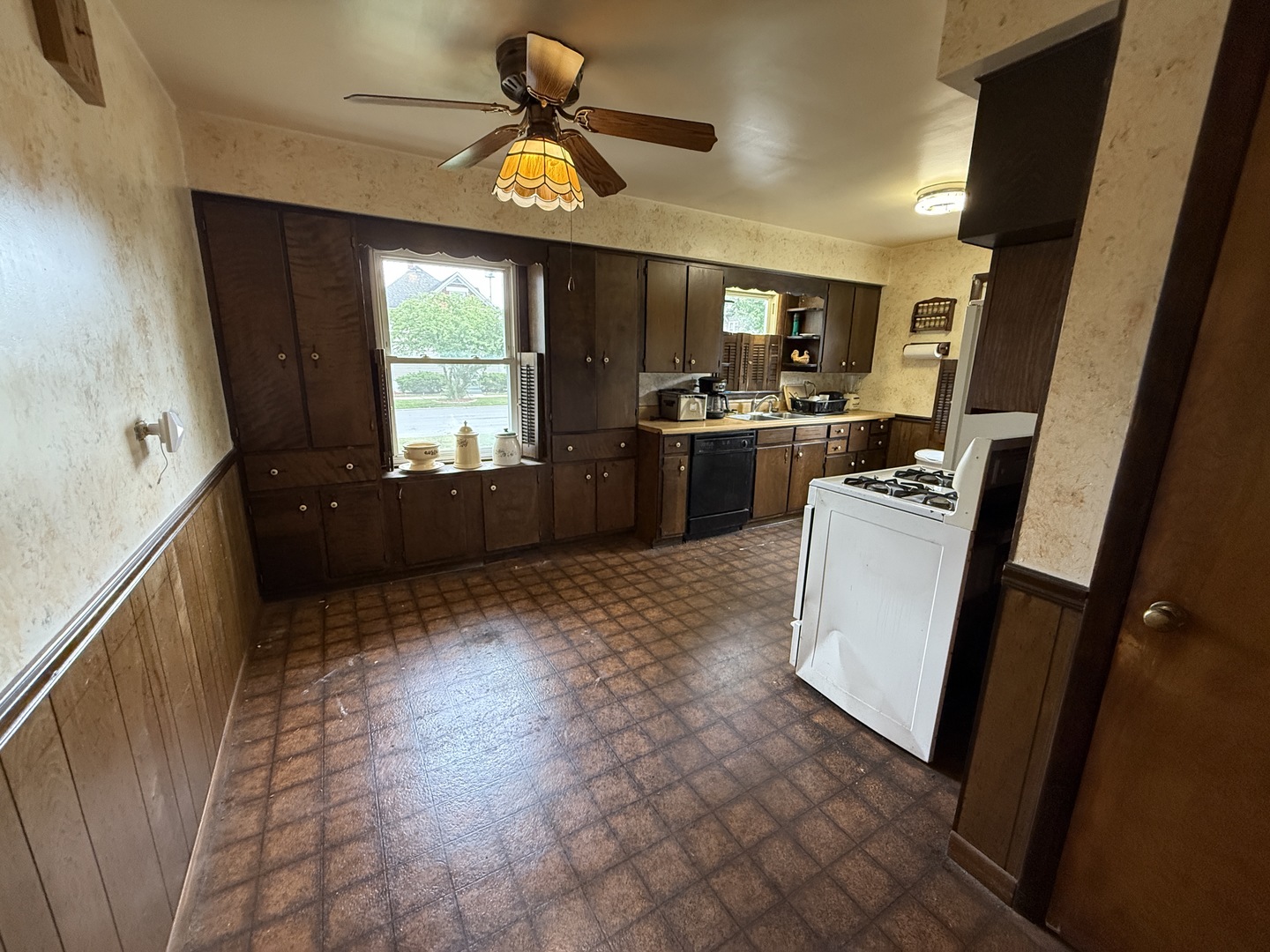 18316 Sherman Street Lansing, IL 60438 - Photo 8 of 14 a kitchen with sink a refrigerator and microwave