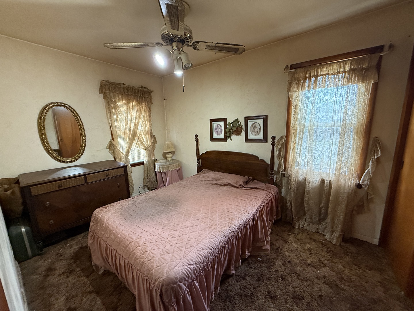 18316 Sherman Street Lansing, IL 60438 - Photo 9 of 14 a bedroom with a bed and a chandelier