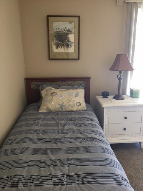 5610 Calle Pacific Carpinteria, CA 93013 - Photo 7 of 8 a bedroom with a bed and a lamp on dresser