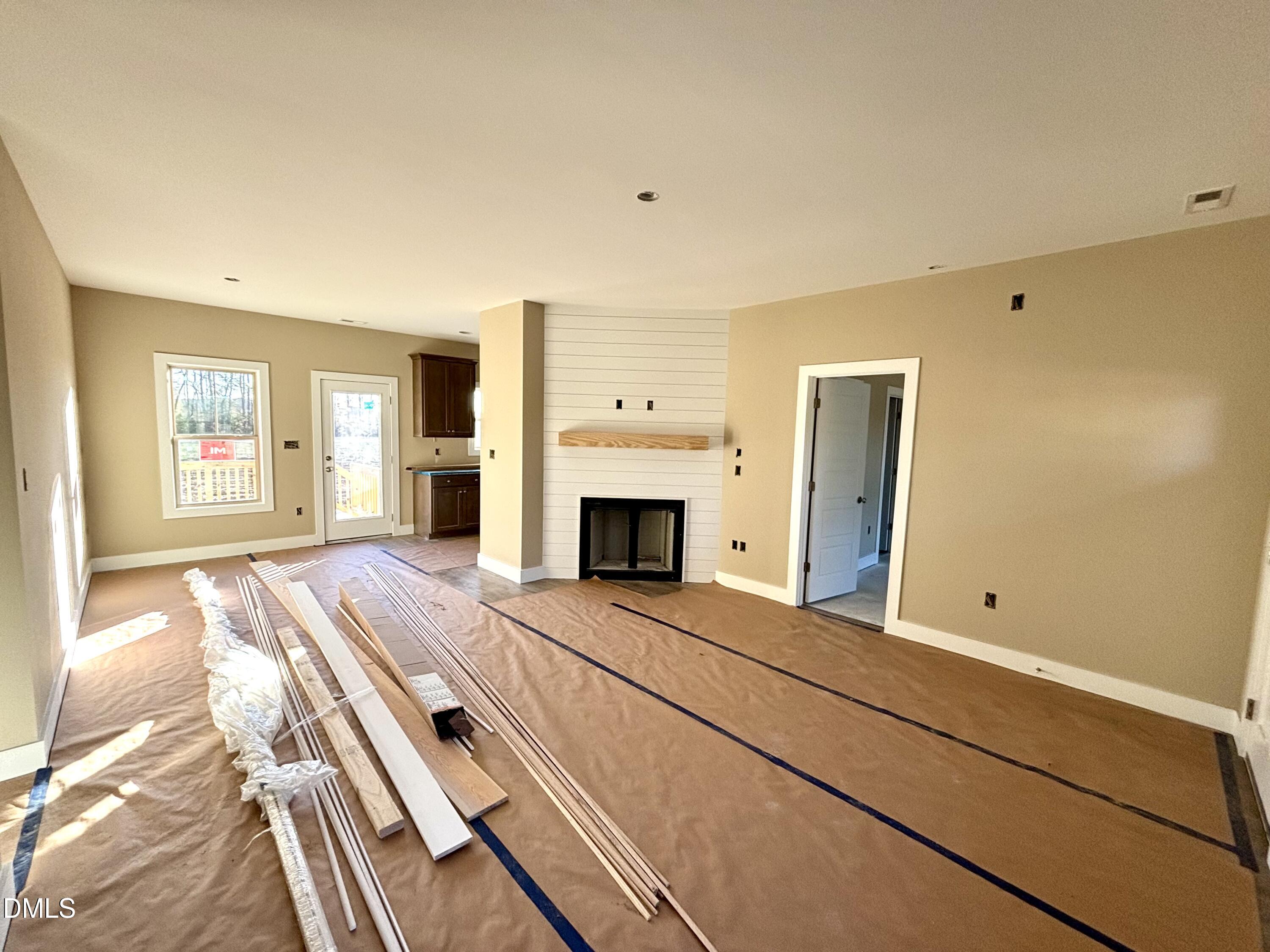 1448 Union Grove Church Road Fremont, NC 27830 - Photo 5 of 21 a view of an empty room with a fireplace and a window