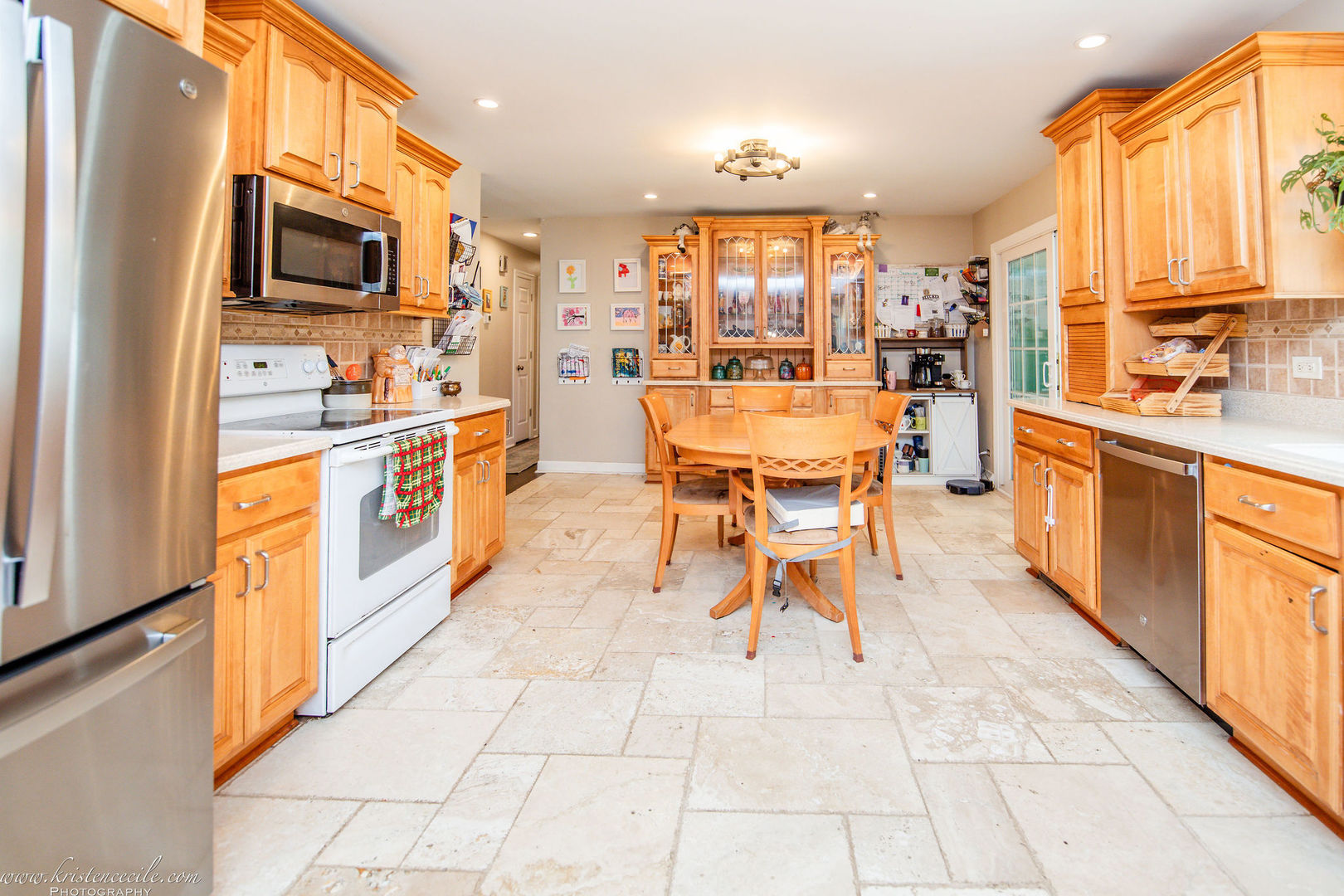 936 West Corning Road Beecher, IL 60401 - Photo 19 of 72 a open kitchen with stainless steel appliances kitchen island granite countertop a refrigerator a stove top oven and a view of living room