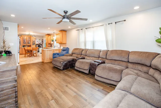 a bedroom with furniture a chandelier and a window