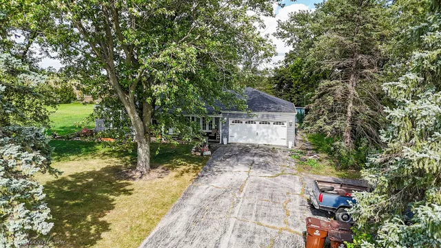 a front view of house with yard and green space
