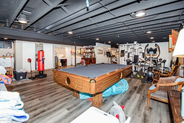 an aerial view of a house with a yard basket ball court and outdoor seating