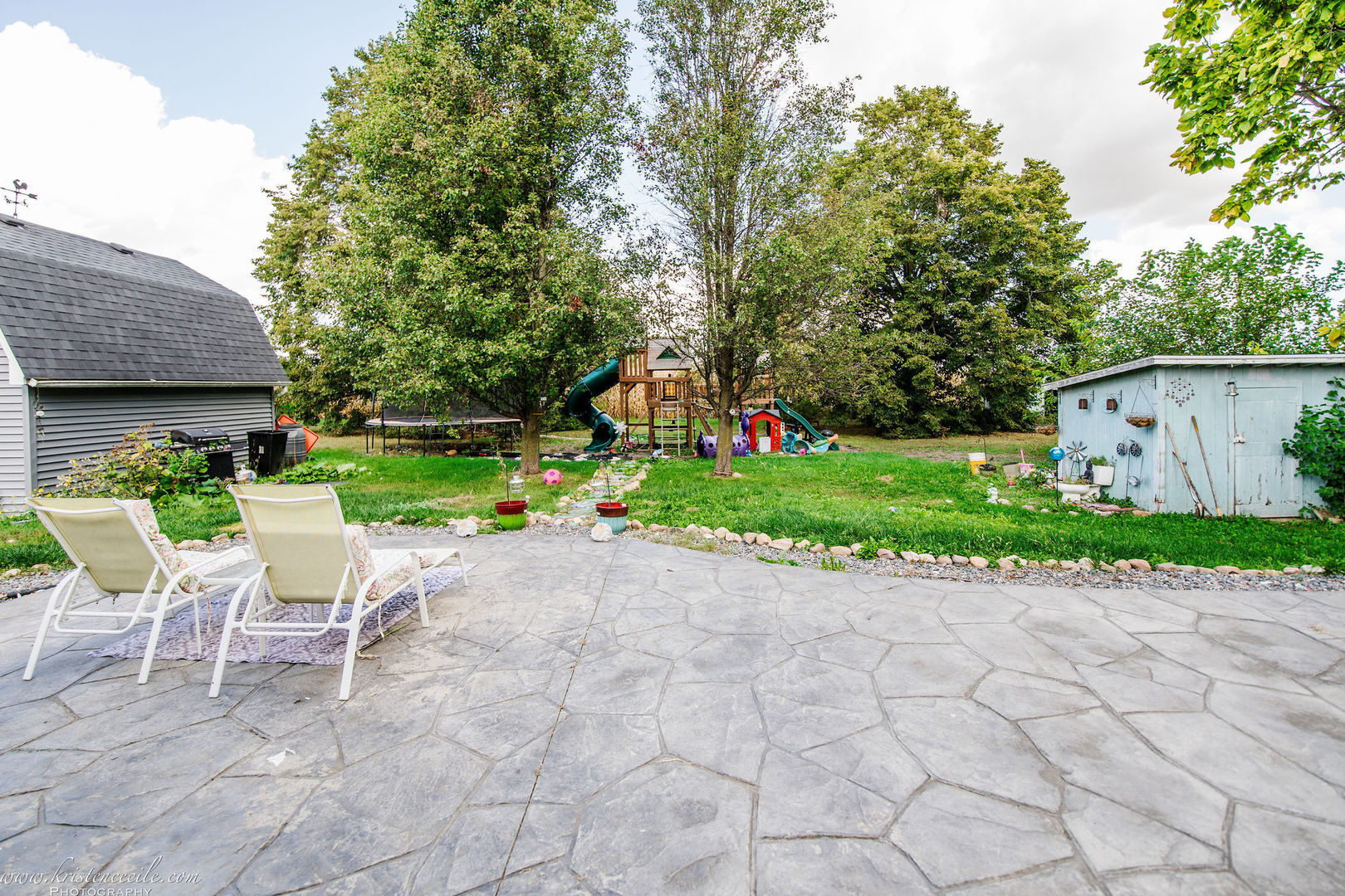 936 West Corning Road Beecher, IL 60401 - Photo 59 of 72 a white bench sitting in a yard with plants and large trees