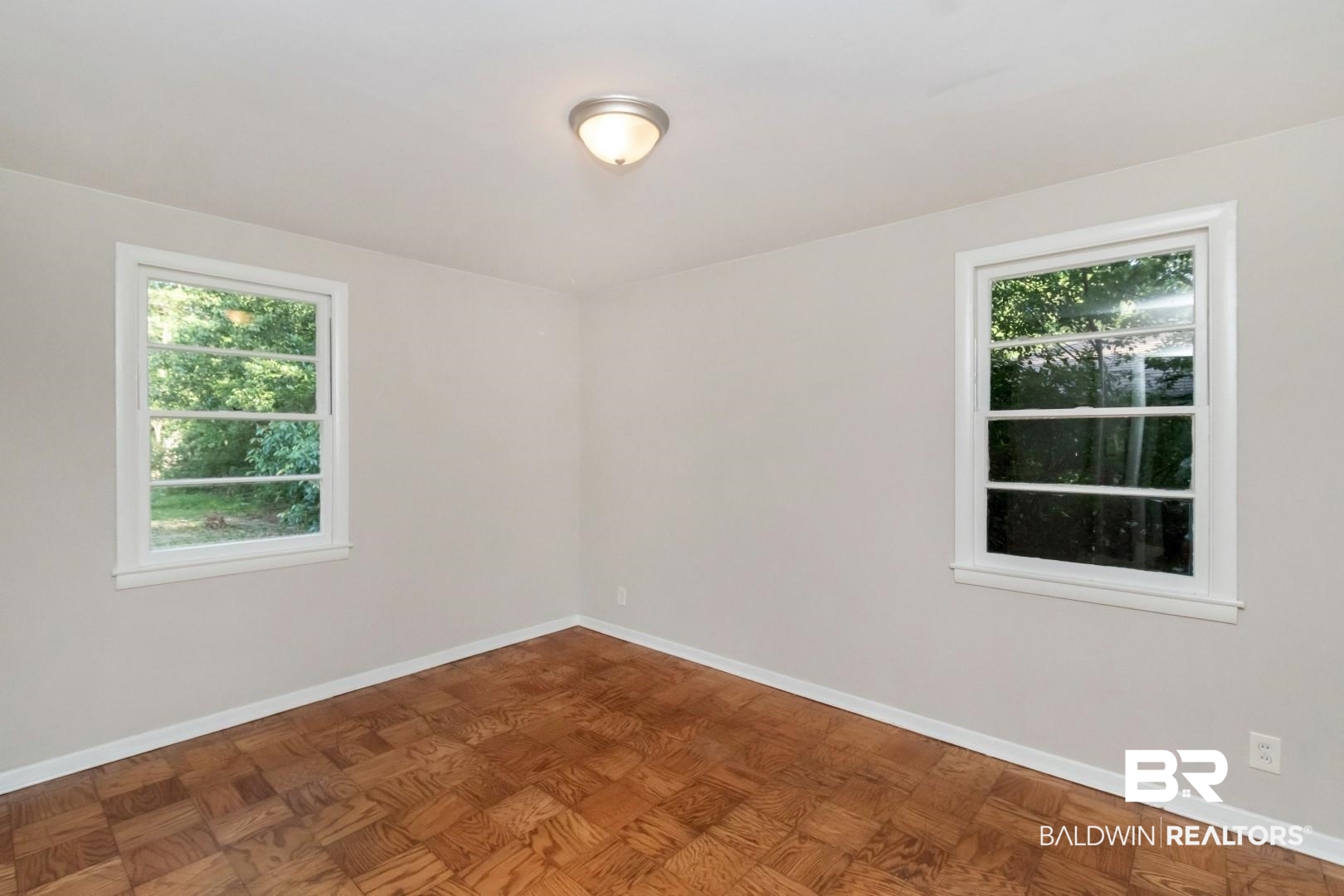 1220 Garland Drive Mobile, AL 36618 - Photo 19 of 25 Spare room featuring plenty of natural light and parquet floors