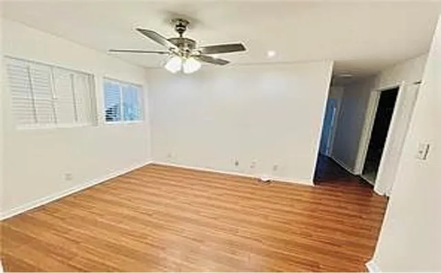 a view of a room with wooden floor and cabinet