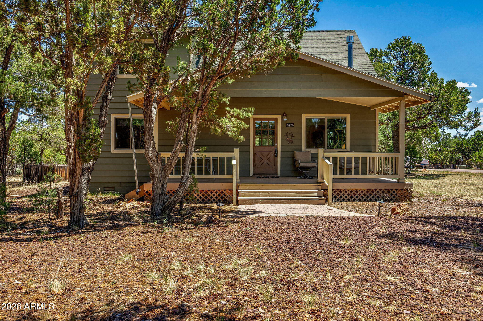 3475 Roundup Circle Heber, AZ 85928 - Photo 2 of 34 a view of house with a yard and large tree