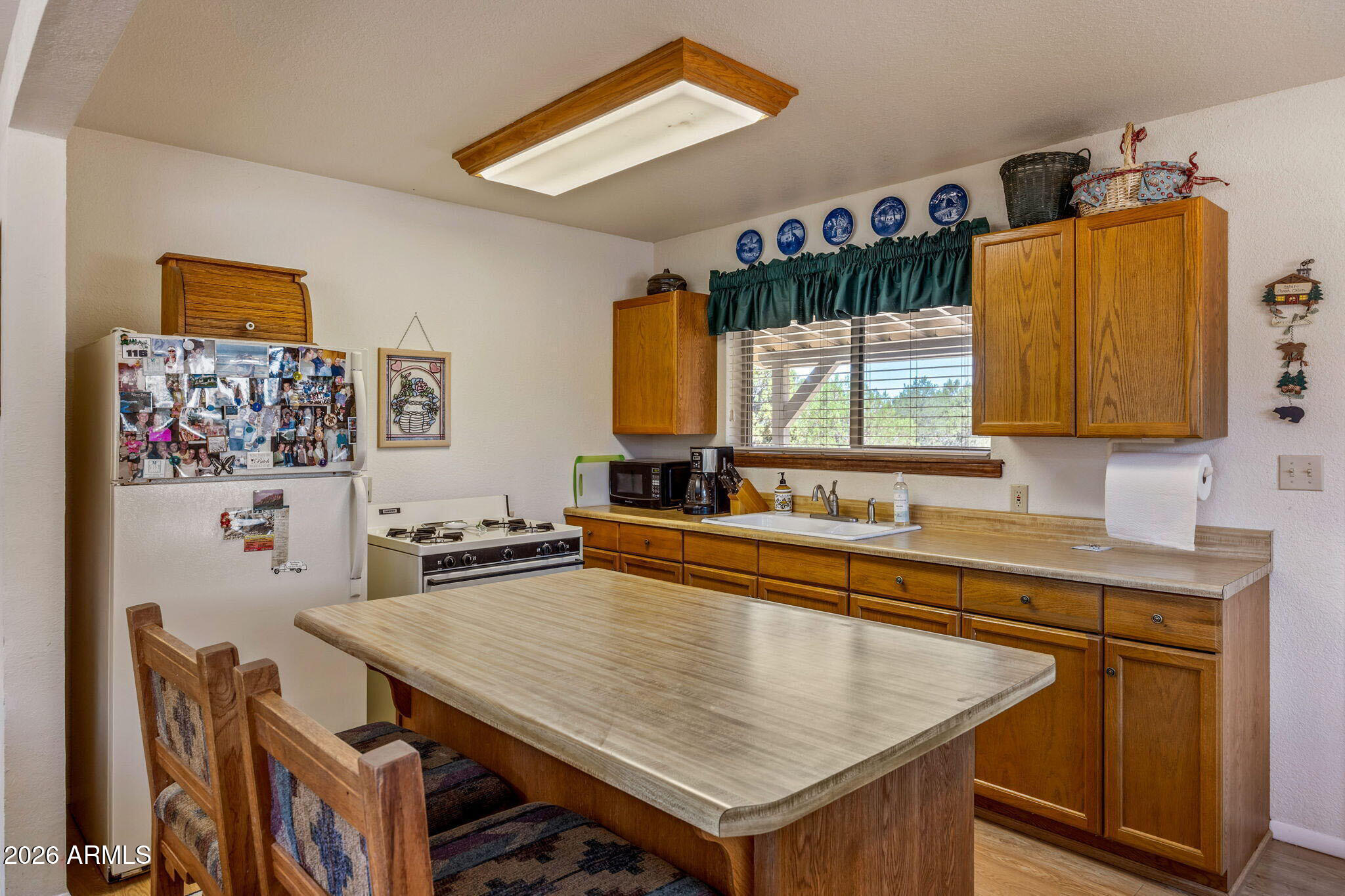 3475 Roundup Circle Heber, AZ 85928 - Photo 10 of 34 a kitchen with stainless steel appliances a sink and a refrigerator