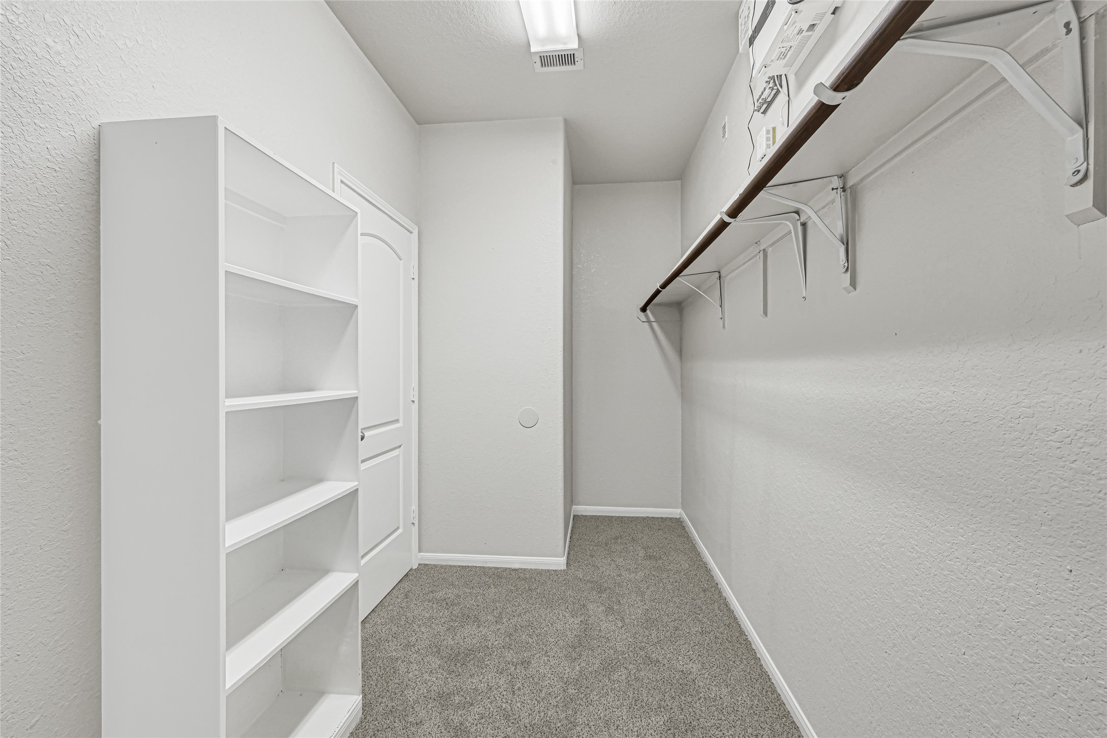 4702 Sedgewood Drive Rosenberg, TX 77471 - Photo 22 of 24 The primary bedroom has a spacious walk-in closet with built-in shelves.