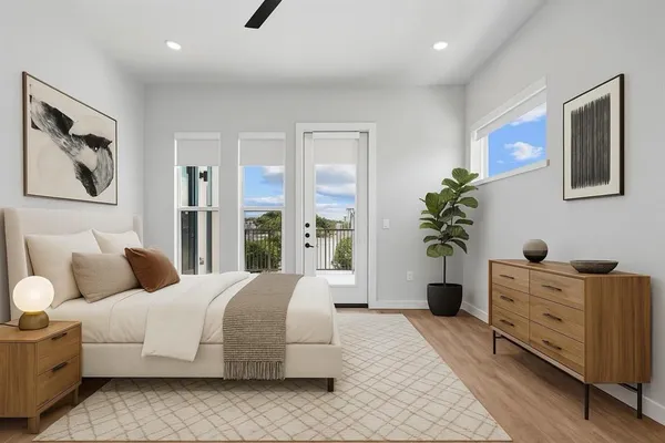 a bedroom with a large bed and a potted plant