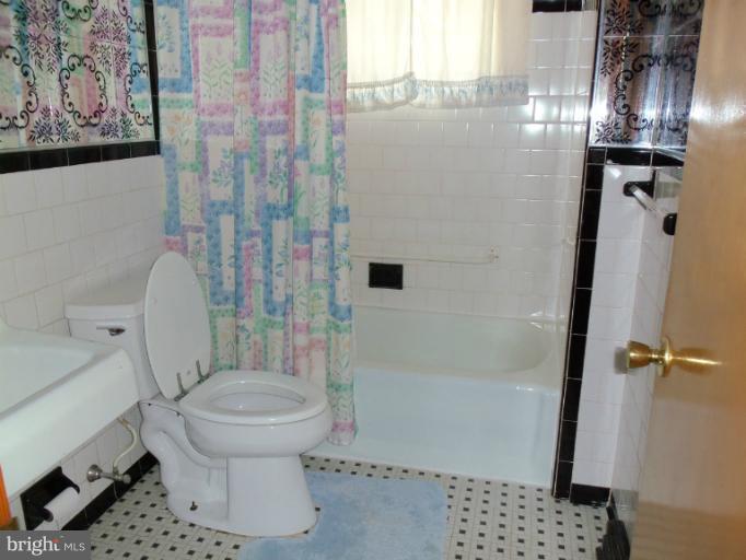 8010 Sagramore Road Rosedale, MD 21237 - Photo 4 of 14 a bathroom with a toilet and shower