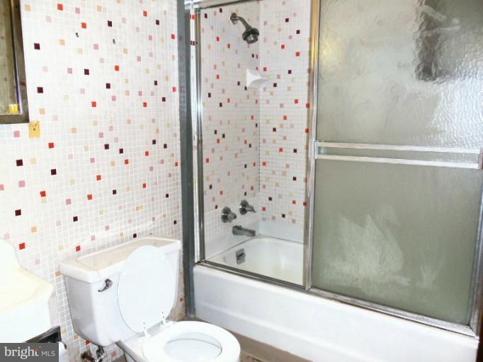 8010 Sagramore Road Rosedale, MD 21237 - Photo 7 of 14 a bathroom with a bathtub and a shower