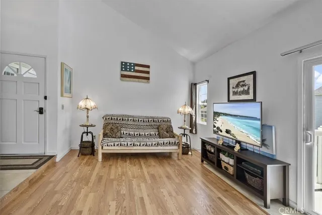 a view of a room with wooden floor and furniture
