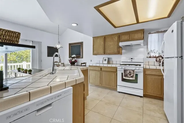 a kitchen with a sink stove and refrigerator