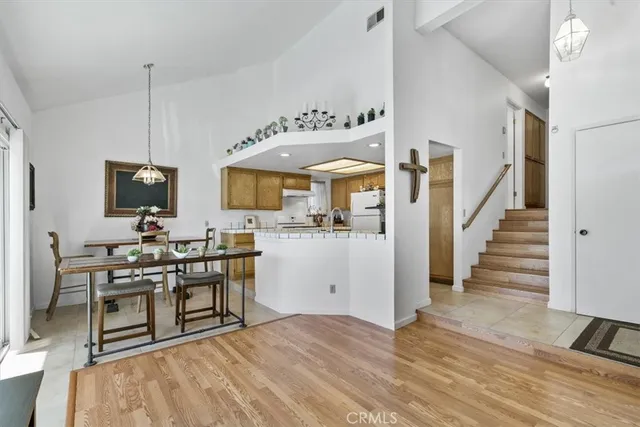 a dining room with furniture and wooden floor