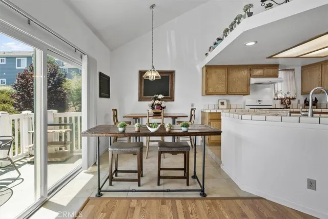 a view of a dining room with furniture a chandelier and wooden floor