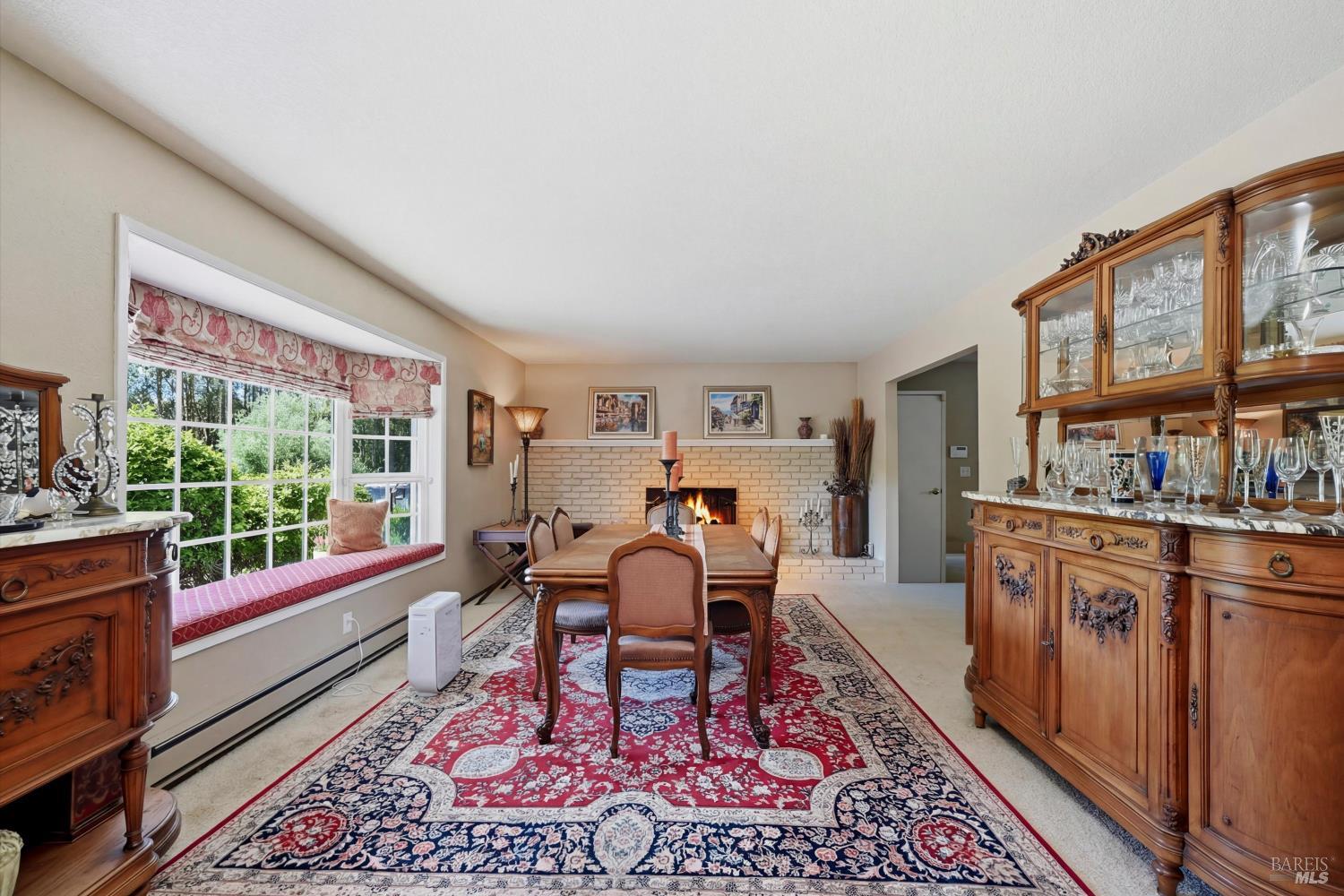 4320 Roblar Road Petaluma, CA 94952 - Photo 19 of 59 Living room, currently used as a formal dining room has a bay window and wood burning fireplace.