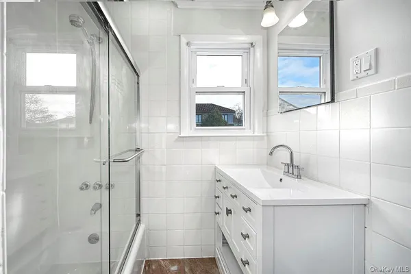 a bathroom with a sink a mirror and a shower