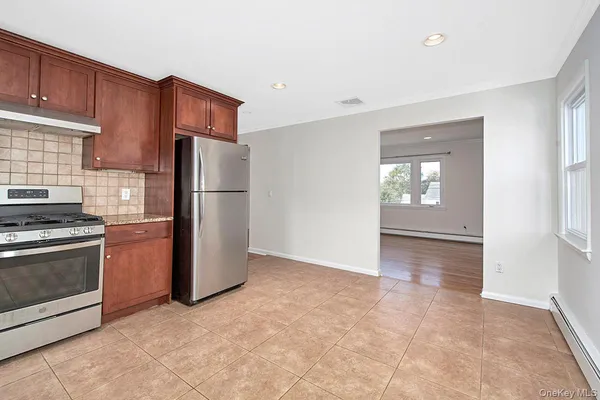 a kitchen with a refrigerator and a stove top oven
