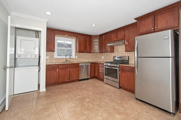 a kitchen with stainless steel appliances granite countertop a refrigerator sink and cabinets