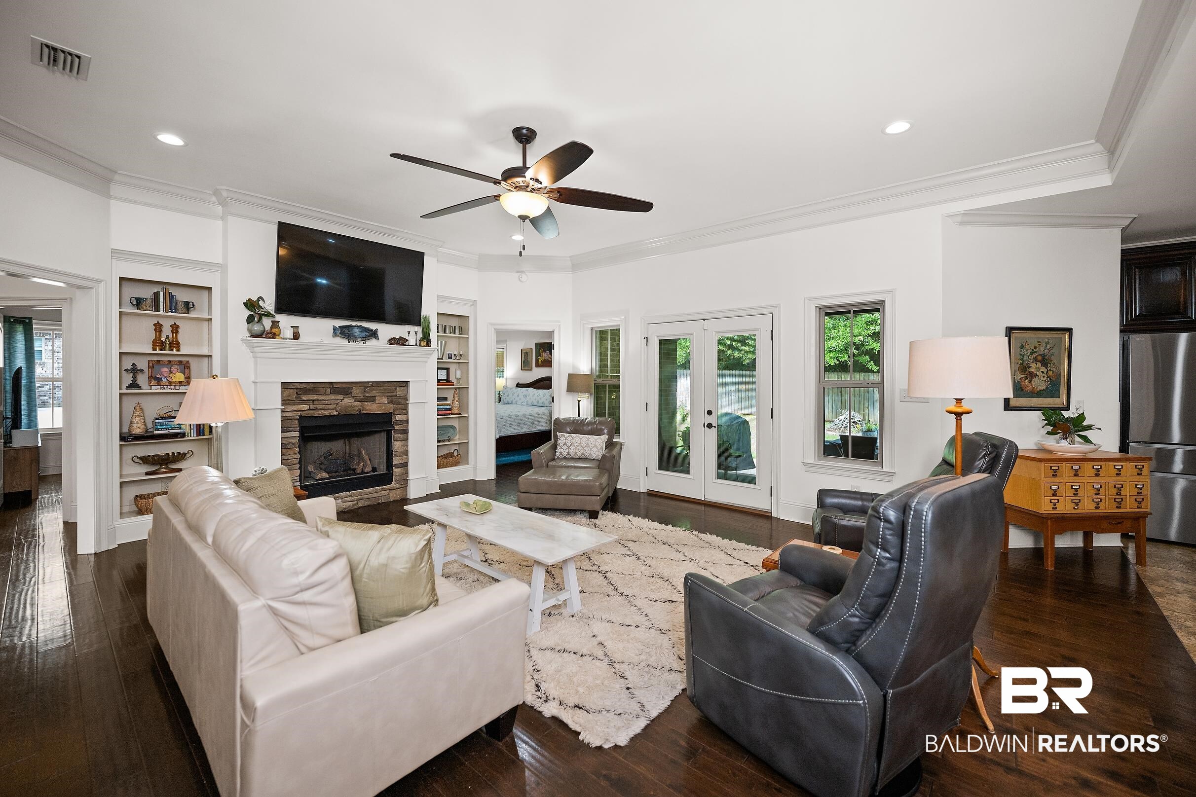 313 Pecan Ridge Boulevard Fairhope, AL 36532 - Photo 2 of 51 Spacious living area featuring dark wood-finish flooring and white crown molding