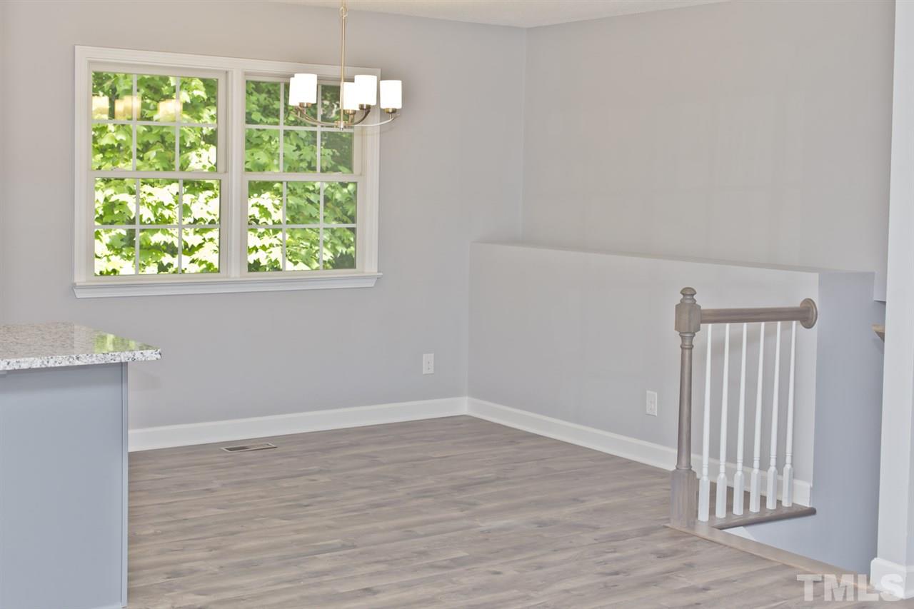 317 East Pilot Street Durham, NC 27707 - Photo 14 of 30 an empty room with wooden floor and windows