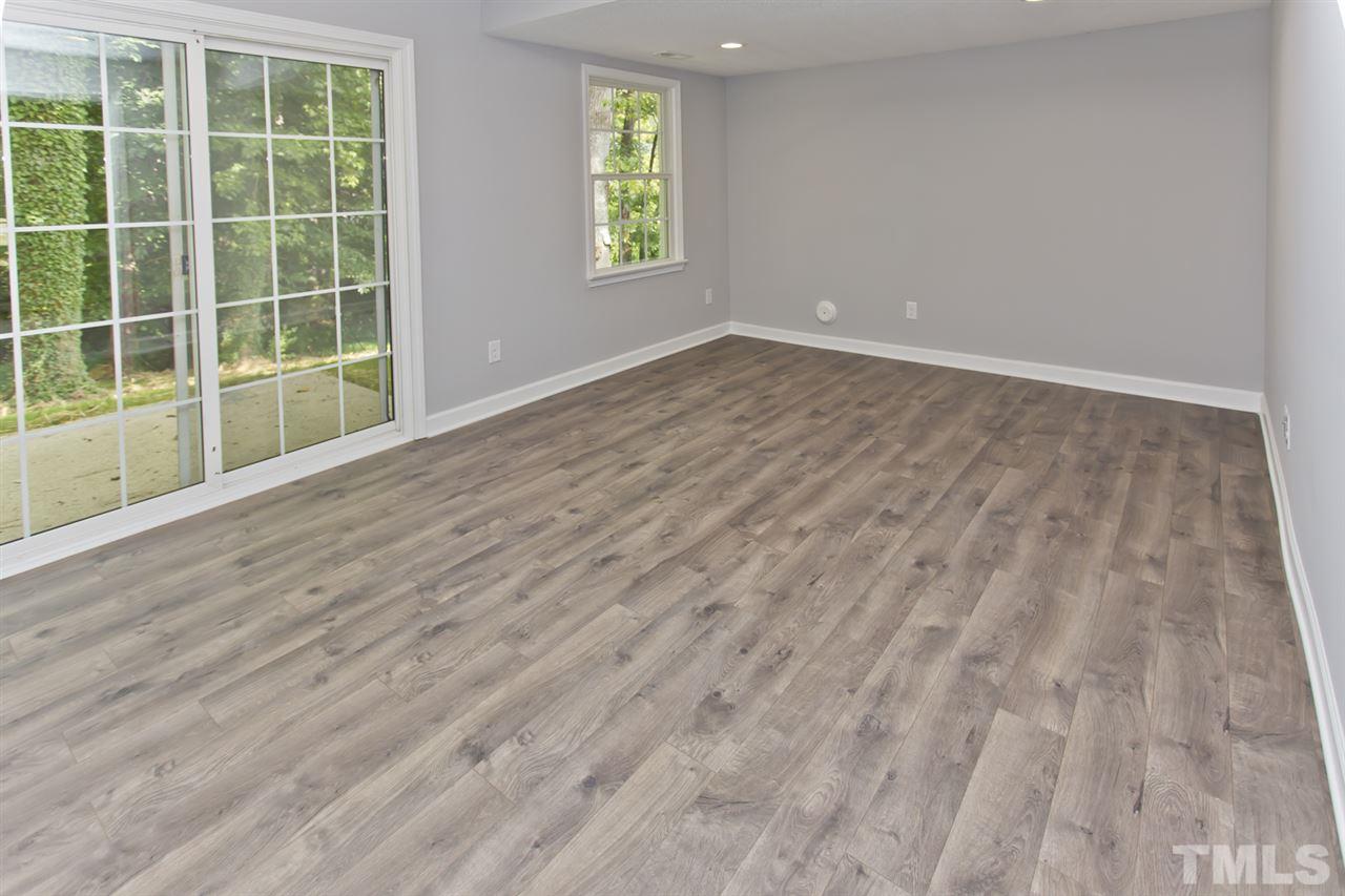 317 East Pilot Street Durham, NC 27707 - Photo 15 of 30 an empty room with wooden floor and windows