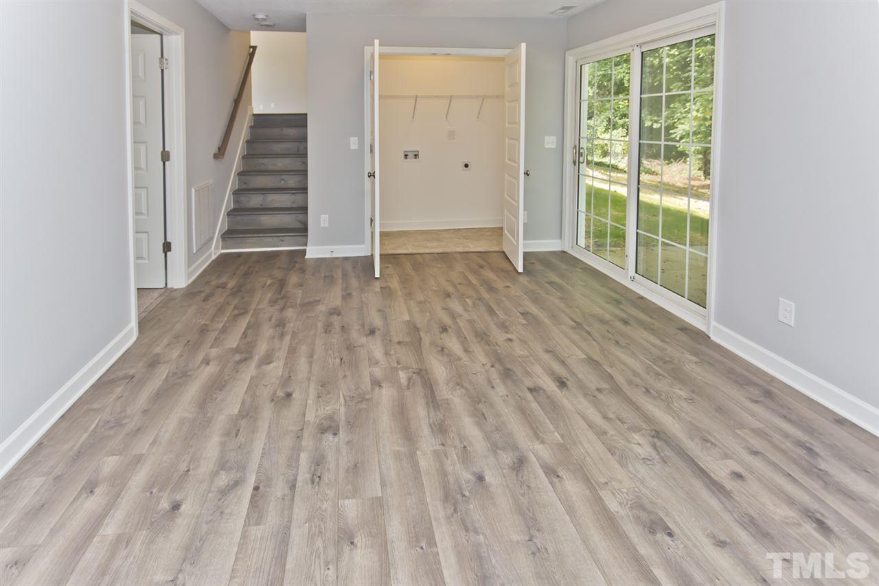 317 East Pilot Street Durham, NC 27707 - Photo 16 of 30 an empty room with wooden floor and windows