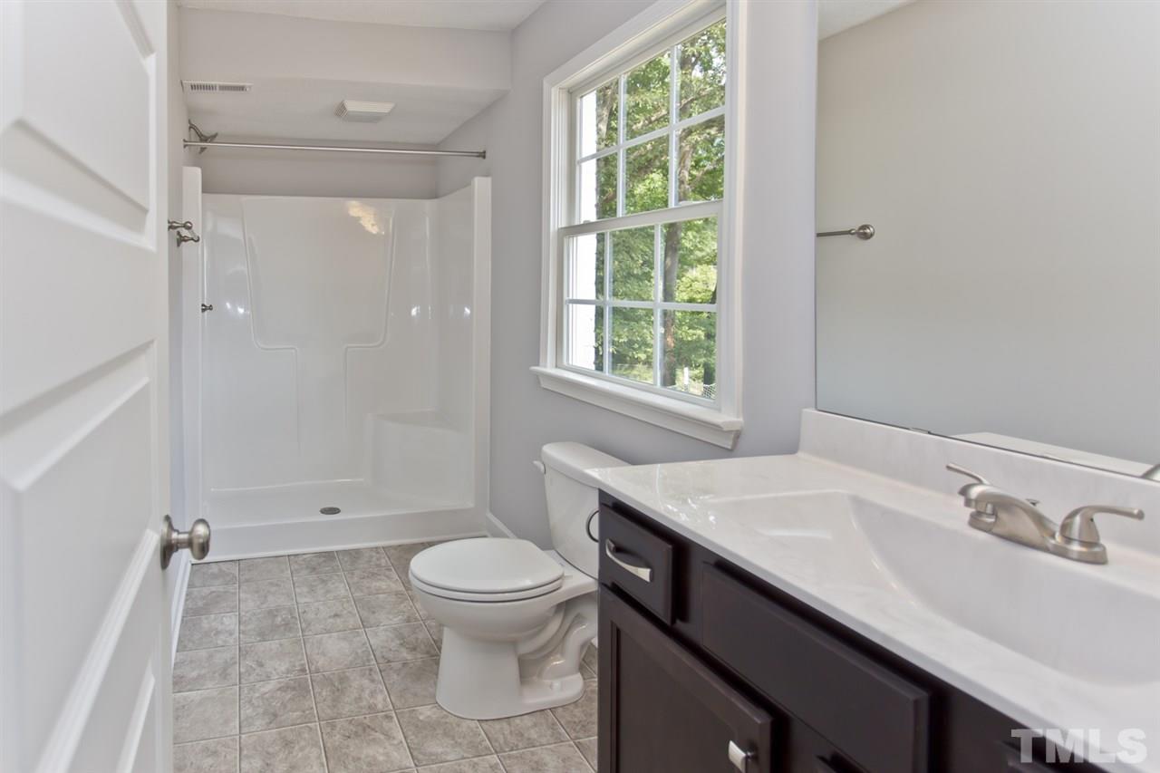 317 East Pilot Street Durham, NC 27707 - Photo 18 of 30 a bathroom with a sink a toilet and shower