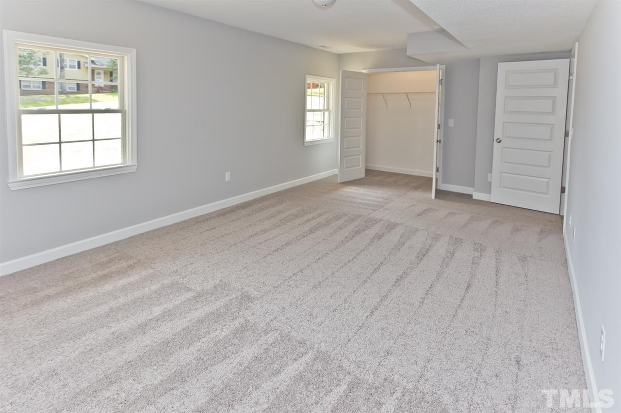 317 East Pilot Street Durham, NC 27707 - Photo 19 of 30 an empty room with windows and closet