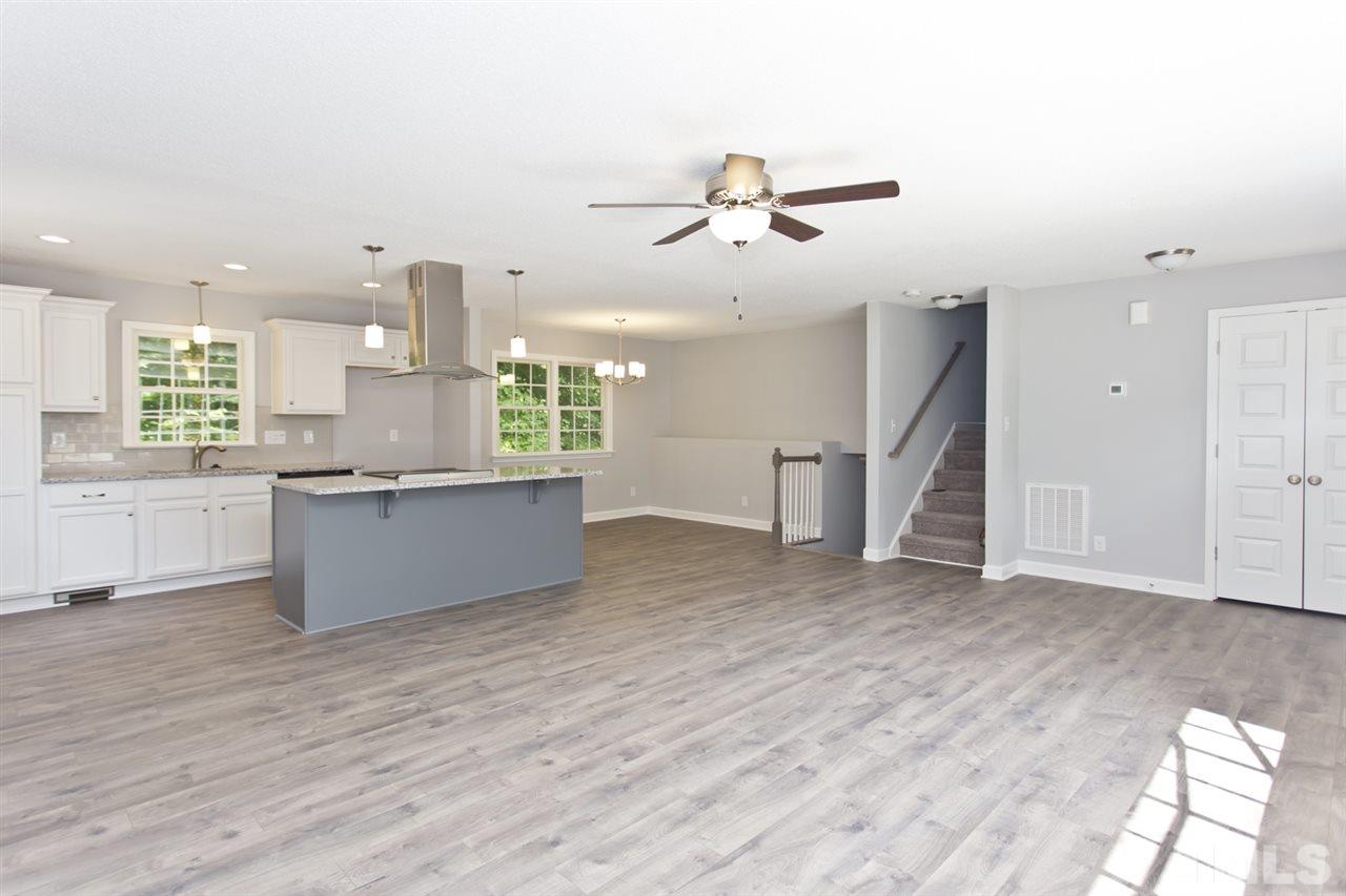317 East Pilot Street Durham, NC 27707 - Photo 5 of 30 a view of a kitchen with kitchen island wooden floors appliances and cabinets