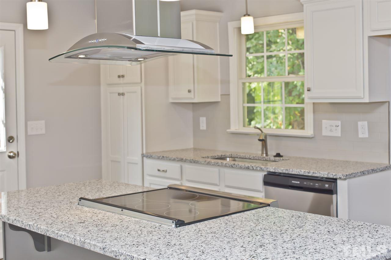 317 East Pilot Street Durham, NC 27707 - Photo 10 of 30 a kitchen with granite countertop a sink and a counter top space