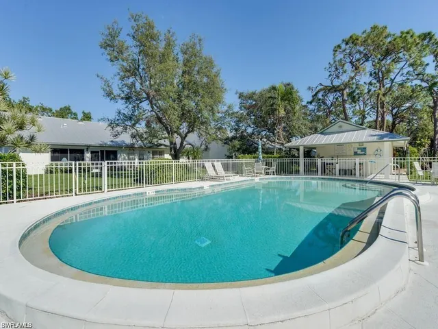 a view of a house with swimming pool and sitting area