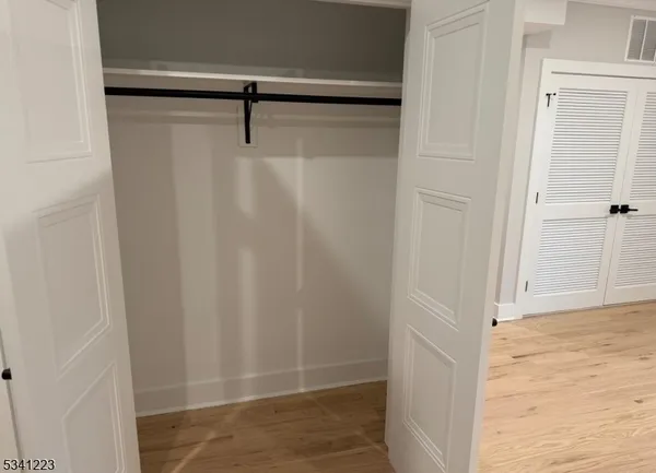a white toilet sitting next to a shower