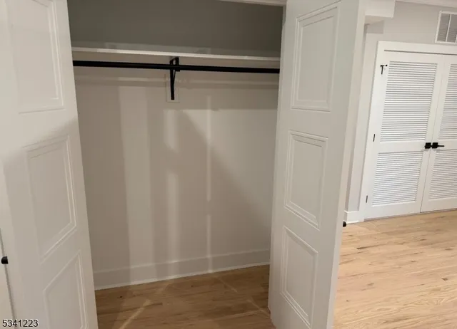 a white toilet sitting next to a shower