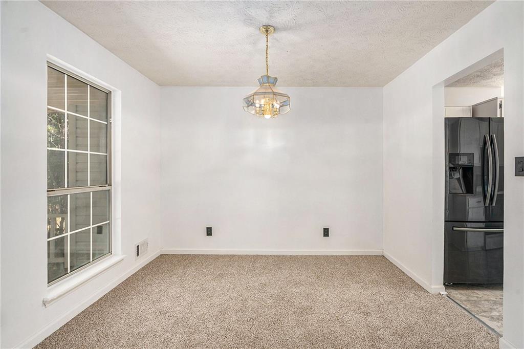 551 Hood Road Stockbridge, GA 30281 - Photo 11 of 49 a view of empty room with windows