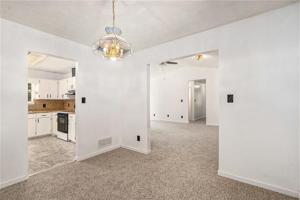551 Hood Road Stockbridge, GA 30281 - Photo 12 of 49 a view of a kitchen with refrigerator and wooden cabinets