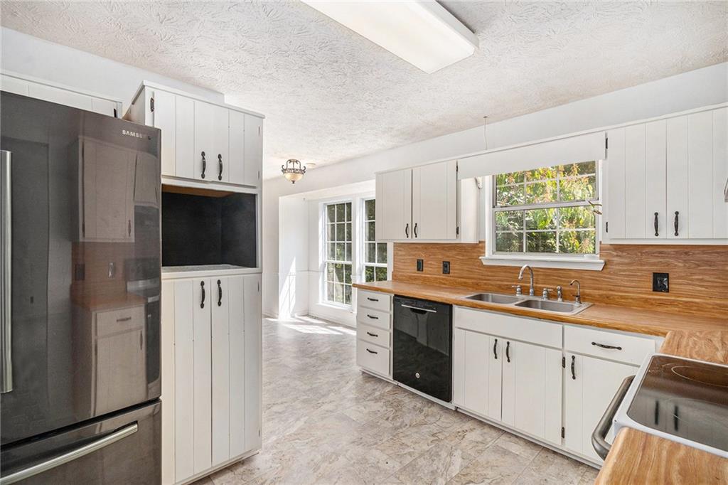 551 Hood Road Stockbridge, GA 30281 - Photo 14 of 49 a kitchen with a sink stove and refrigerator