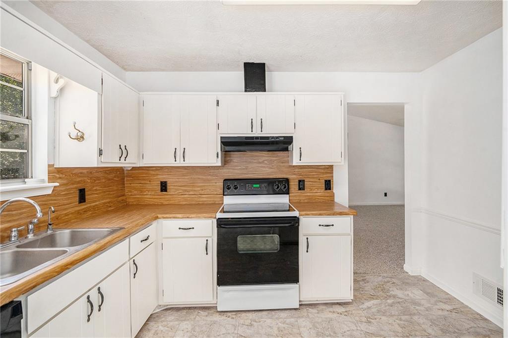 551 Hood Road Stockbridge, GA 30281 - Photo 15 of 49 a kitchen with cabinets appliances and a sink