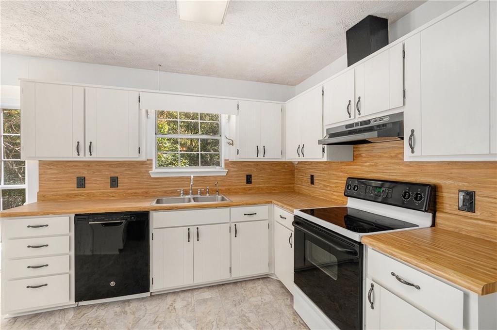 551 Hood Road Stockbridge, GA 30281 - Photo 16 of 49 a kitchen with cabinets appliances a sink and a window