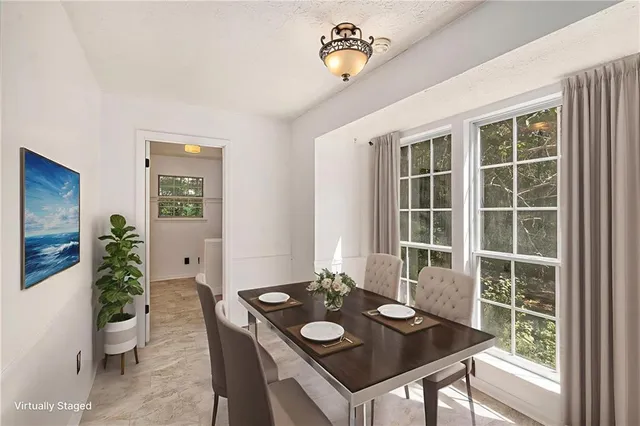 a view of a workspace with furniture and window